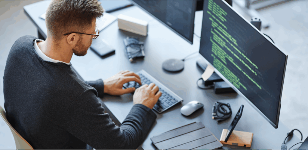 Man working at a desktop computer.