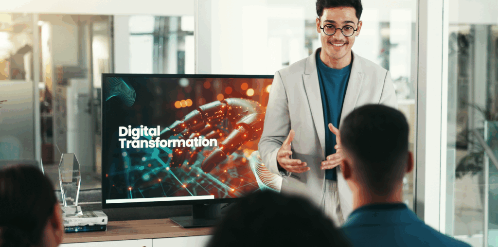 A person standing in front of a screen, talking about digital transformation.