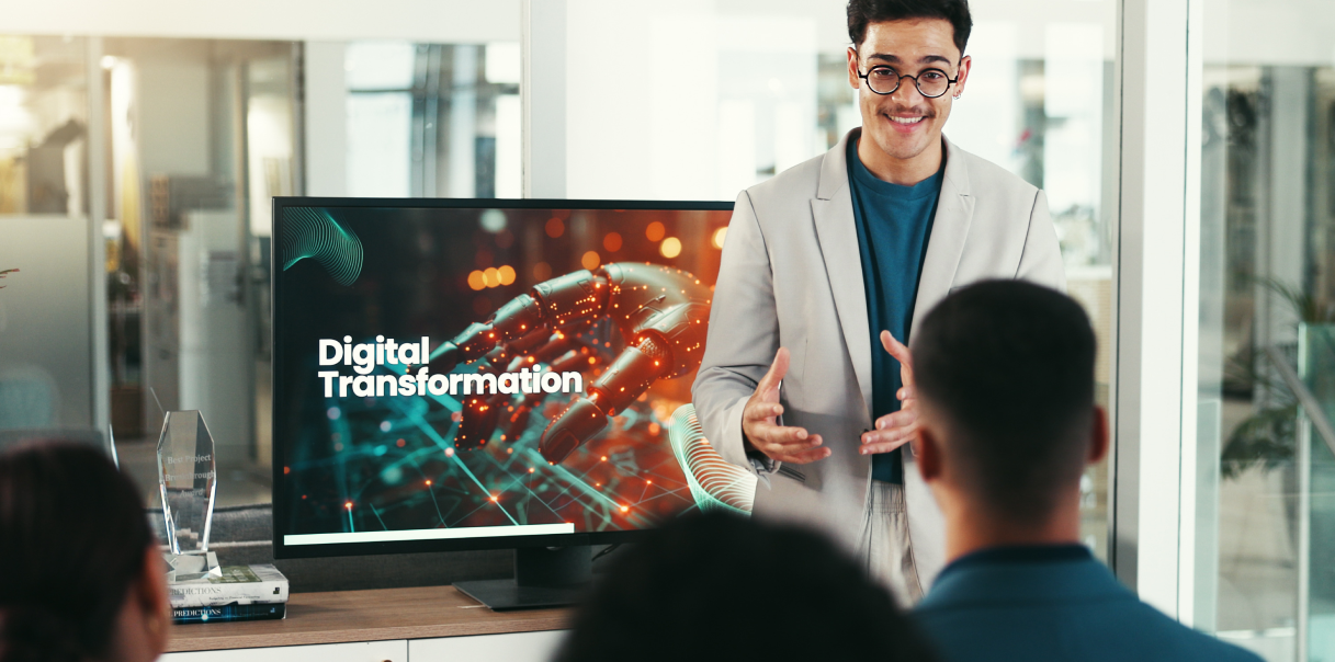 A person standing in front of a screen, talking about digital transformation.