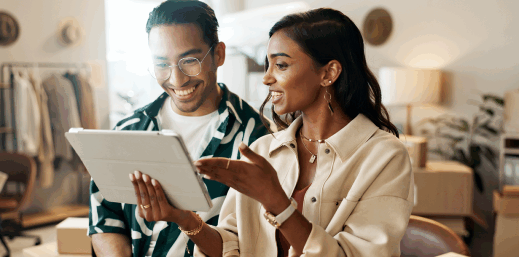 Two people talking while holding an iPad.