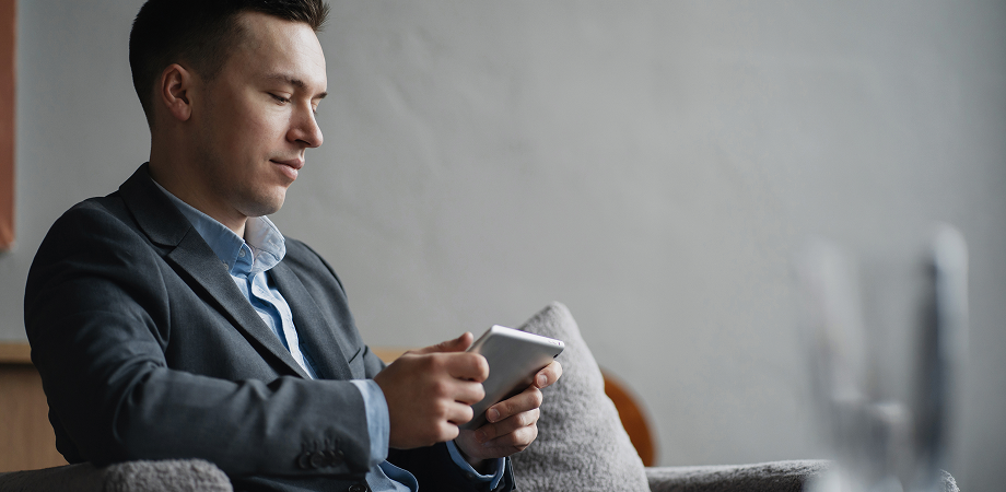A person sitting down and working on a mobile phone.