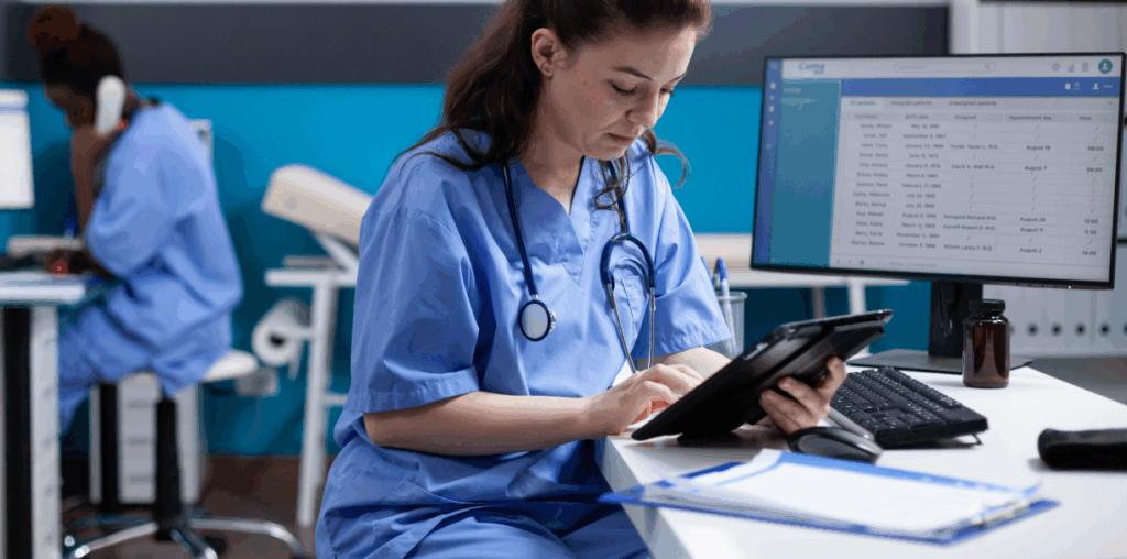 Woman working on an iPad in a medical environment.