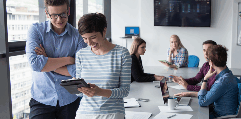 A group of coworkers in a meeting room in an office.