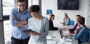 A group of coworkers in a meeting room in an office.