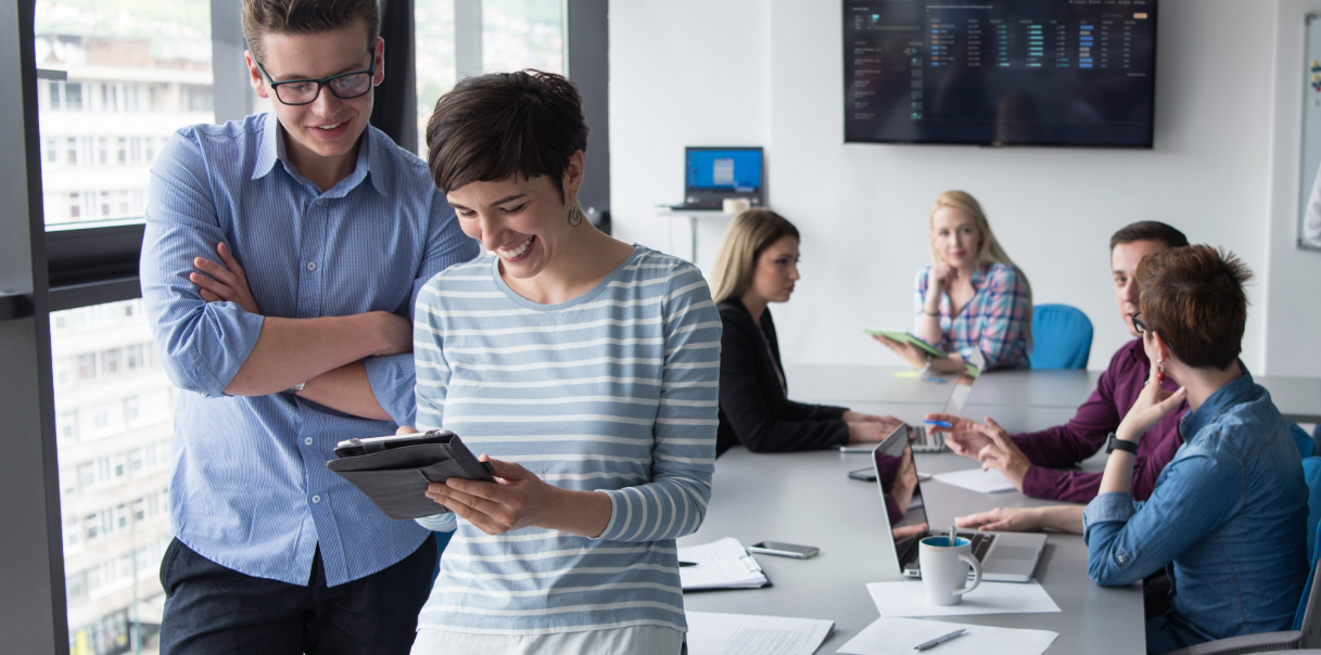 A group of coworkers in a meeting room in an office.