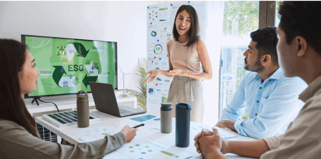 A woman talking to three coworkers in a boardroom about eco-friendly initiatives.