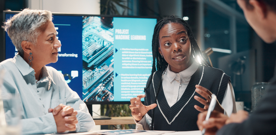 A woman passionately discussing a topic to her two coworkers.