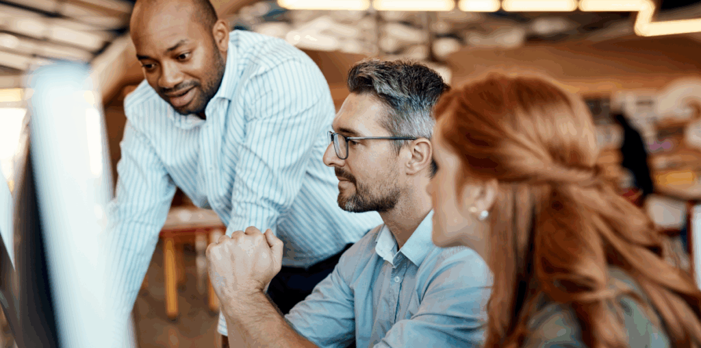 Colleagues working together at a desk.