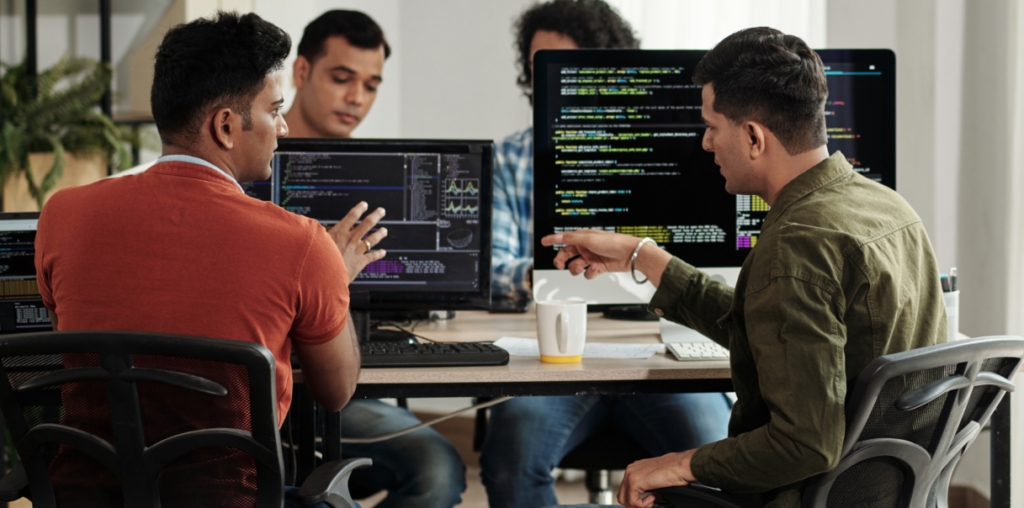 Coworkers looking at computer monitors.