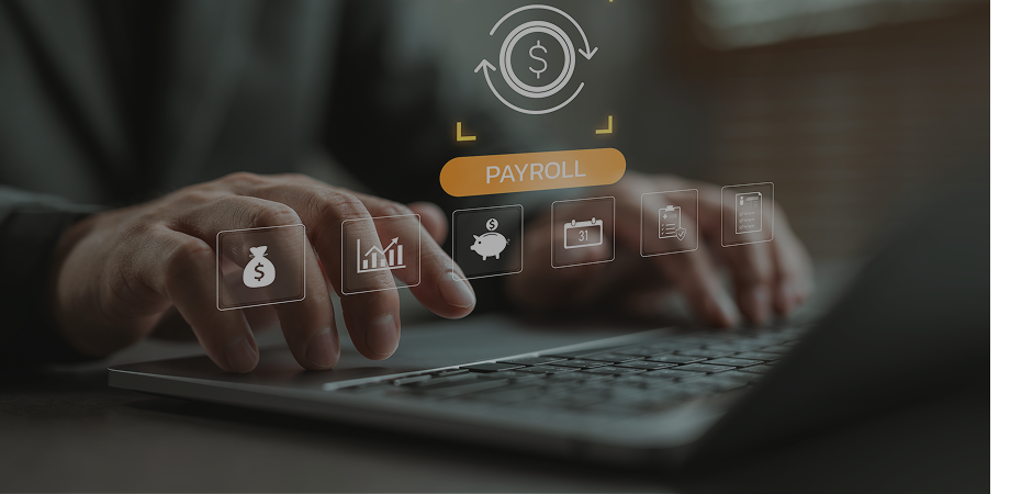 Person using a laptop. Over the keyboard is a hologram of a payroll symbol.